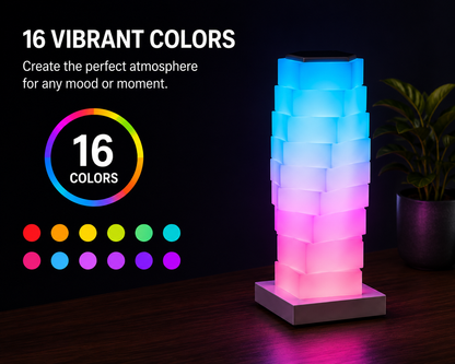 A modern tower-shaped LED light lamp made of stacked square blocks, glowing with a blue-to-pink gradient on a dark surface. Text on the left reads '16 VIBRANT COLORS' with a rainbow circle and color dots, and a potted plant sits on the right against a dark background.