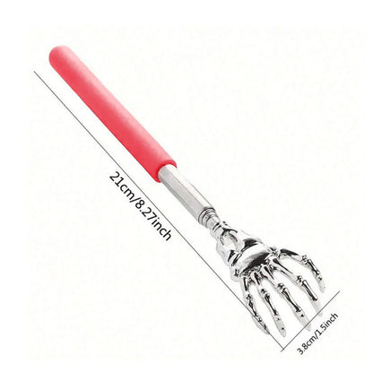 Metallic garden rake with skeleton hand design and red handle on a white background