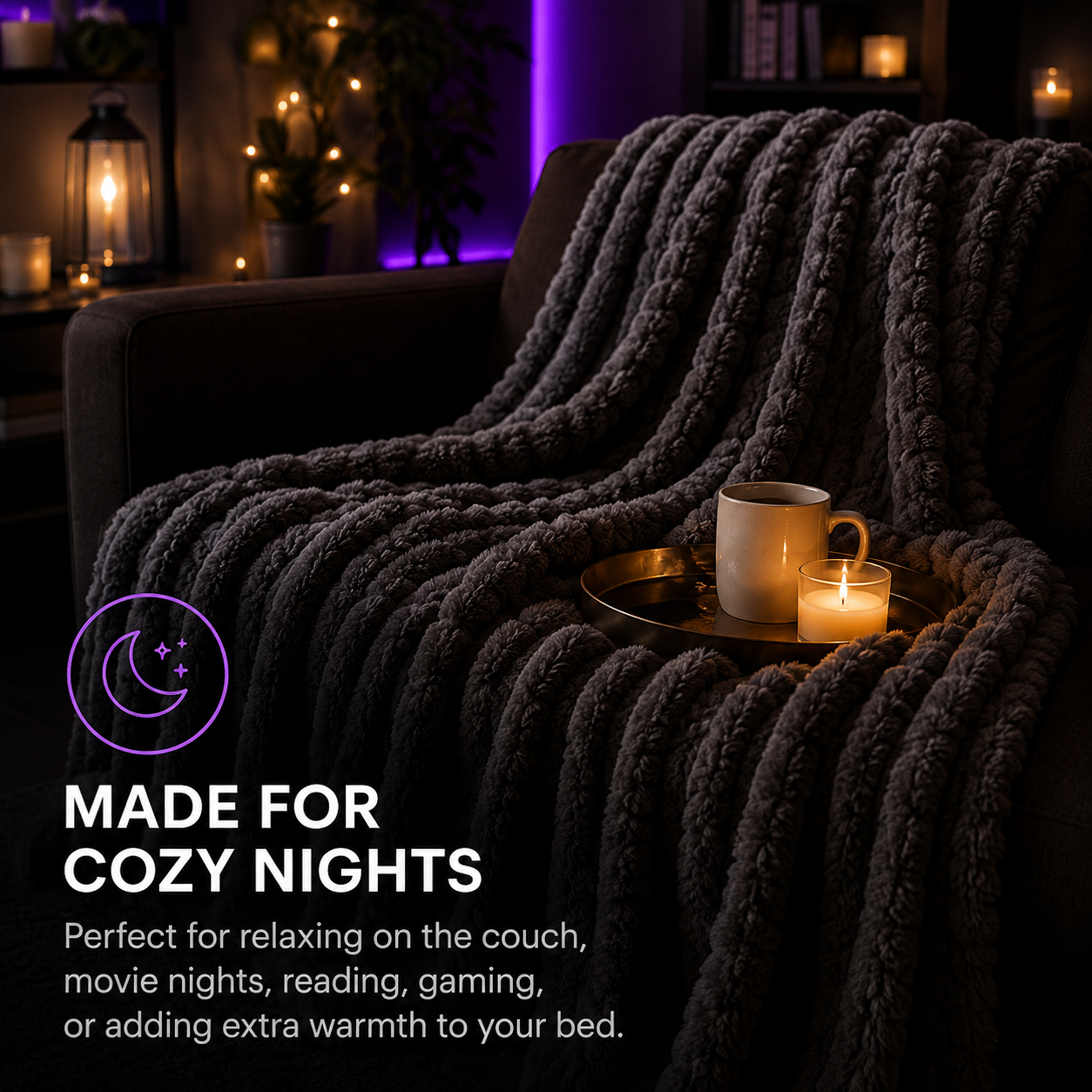 A thick, chunky knit throw blanket in dark charcoal gray draped over a couch in a cozy living room setting, with a mug and candle on a tray. Text on the image reads 'MADE FOR COZY NIGHTS' with descriptive copy below.